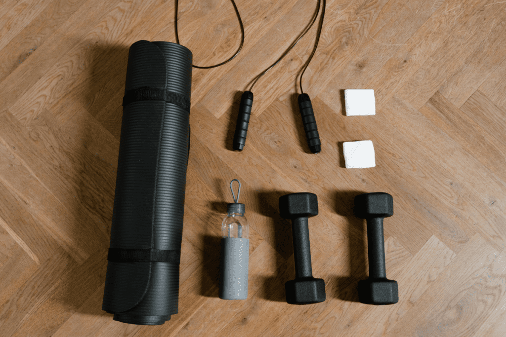reasons to workout, yoga mat, weights, jump rope and water bottle