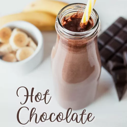 hot chocolate smoothie with a straw and banana and chocolate in background